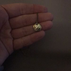 Tiffany and Co. cursive “L” necklace. I never wear